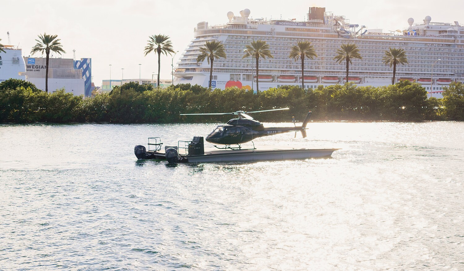 A helicopter on the deck of a boat crossing Biscayne Bay